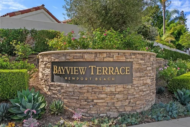 an aerial view of multiple houses with a yard