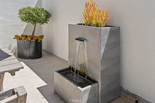 a view of a patio with table and chairs under an umbrella
