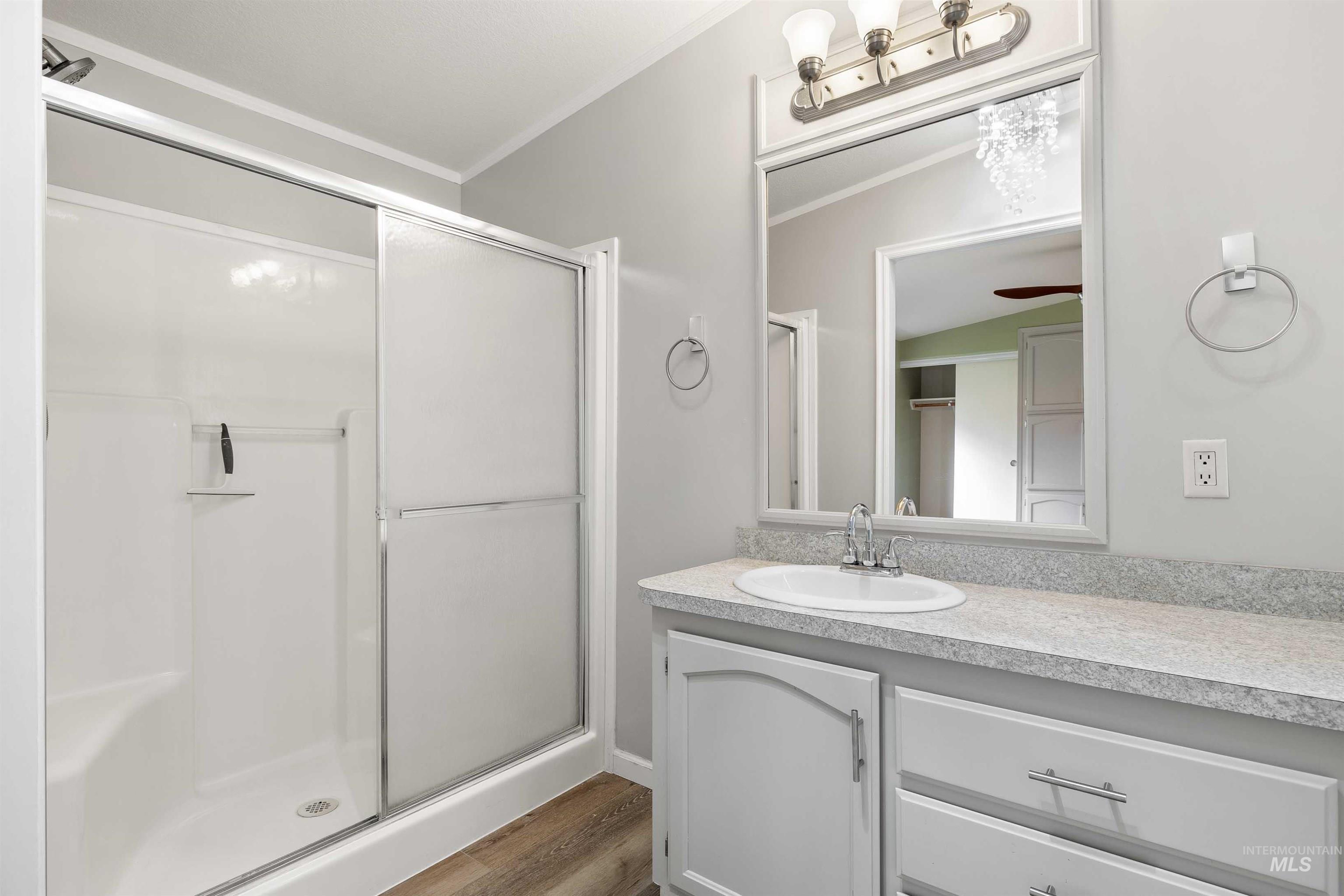 910 Moonglo, Unit 80 Buhl, ID 83316 - Photo 14 of 25 Bathroom featuring a white vanity with an integrated sink, a speckled countertop, and a large framed mirror