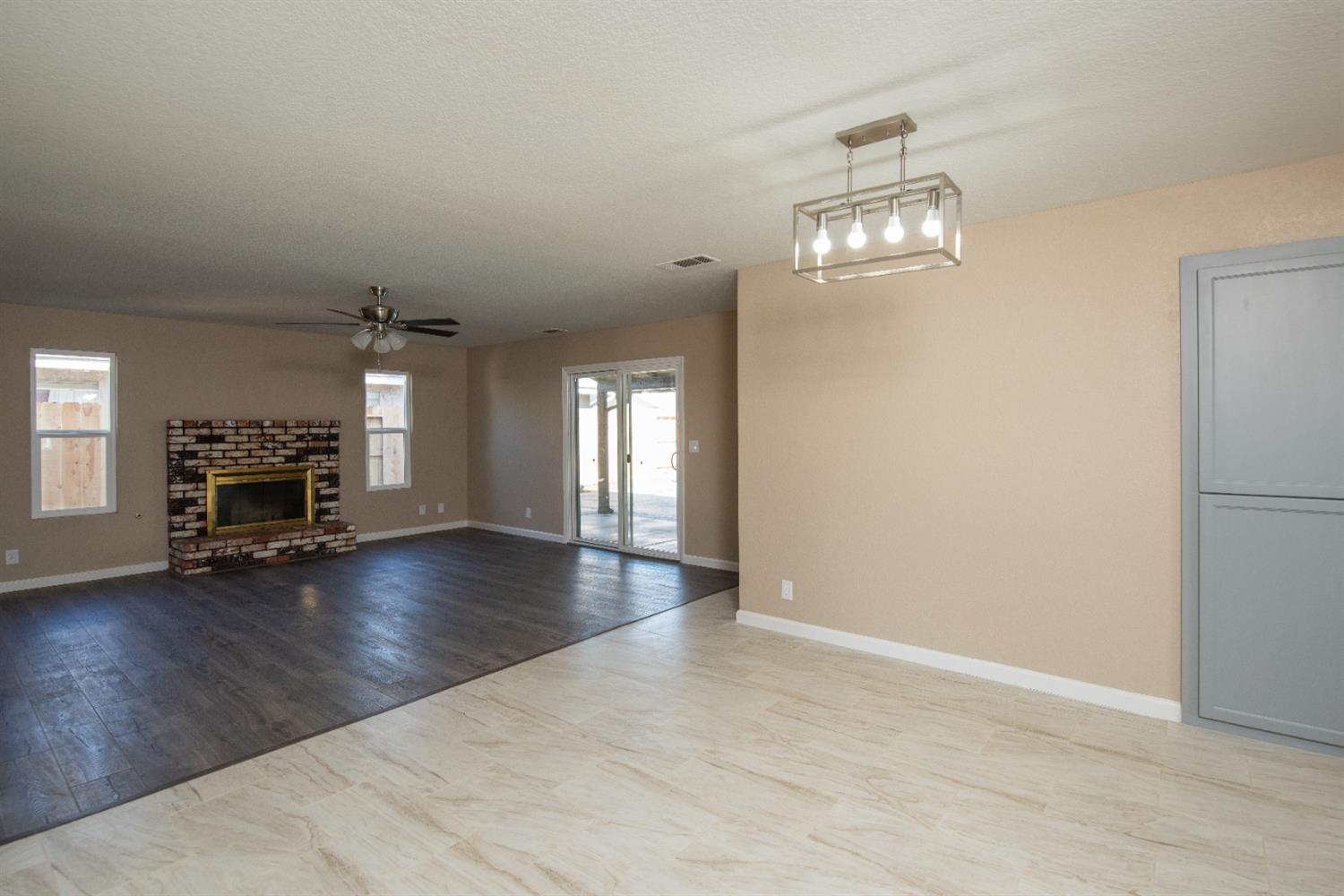 1621 Davis Street Ripon, CA 95366 - Photo 14 of 43 a view of livingroom with wooden floor fireplace and window