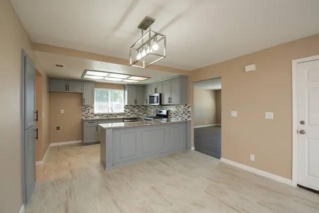 a kitchen with a refrigerator and a sink