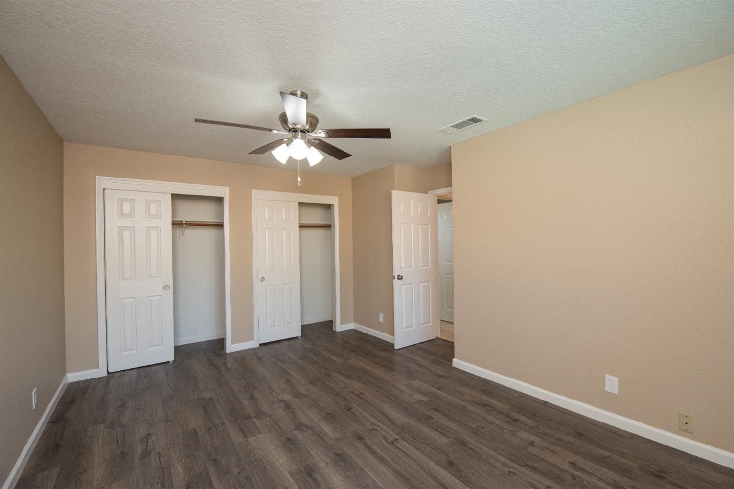 1621 Davis Street Ripon, CA 95366 - Photo 24 of 43 a view of an empty room with wooden floor
