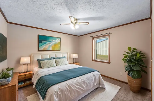 an empty room with a window and a ceiling fan