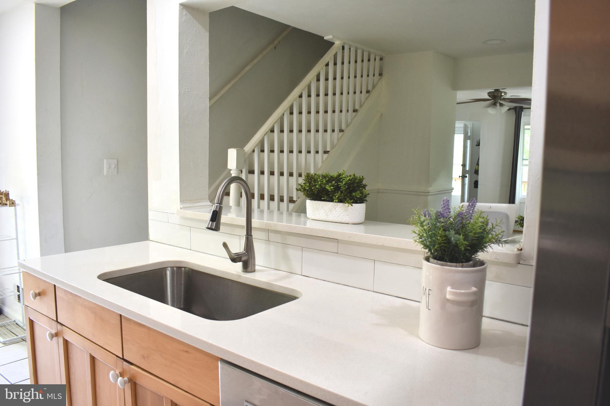 19127 Windsor Road Triangle, VA 22172 - Photo 1 of 33 a kitchen with a sink and potted plant