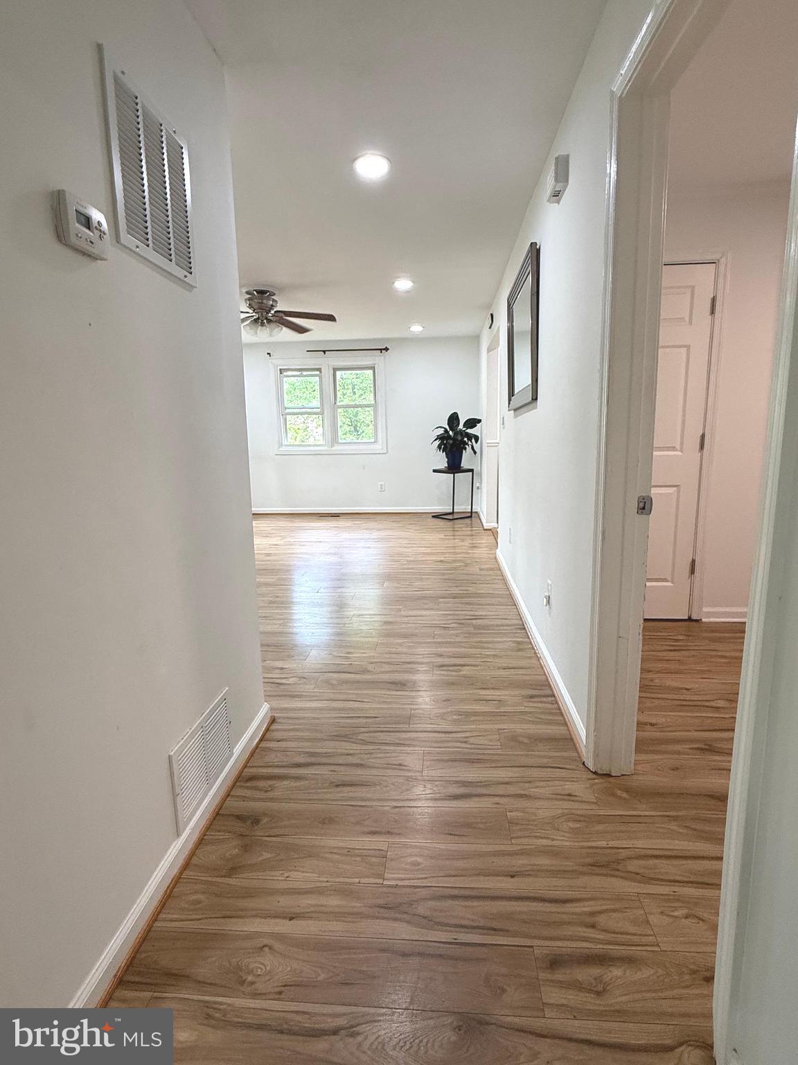 19127 Windsor Road Triangle, VA 22172 - Photo 11 of 33 a view of a hallway with wooden floor and staircase