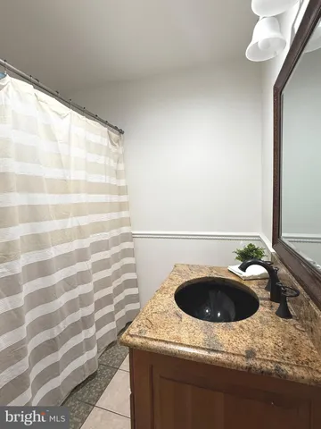 a bathroom with a sink and granite top