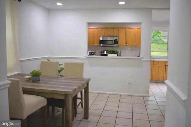 a kitchen with a table and chairs in it