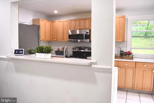 a kitchen with a sink a refrigerator and cabinets
