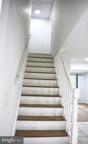 a view of staircase with open kitchen view