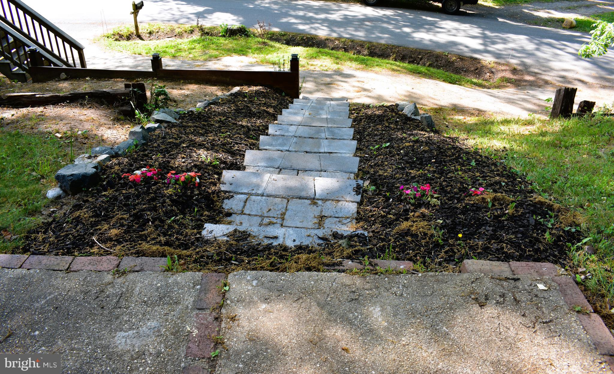 19127 Windsor Road Triangle, VA 22172 - Photo 26 of 33 a view of a pathway with a flower garden