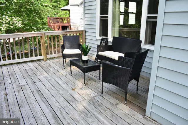a balcony with wooden floor and furniture