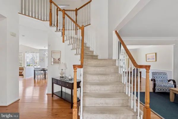 a view of stairs and dining room with wooden floor