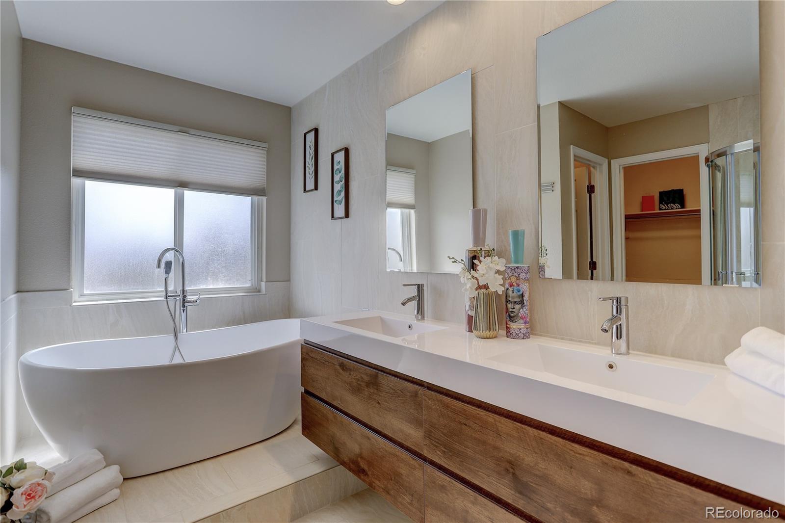 a bathroom with sink bathtub and mirror