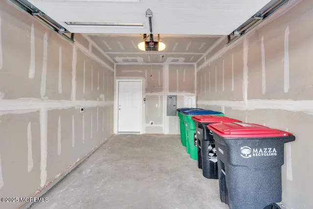 a utility room with stainless steel appliances kitchen island granite countertop furniture and a shower