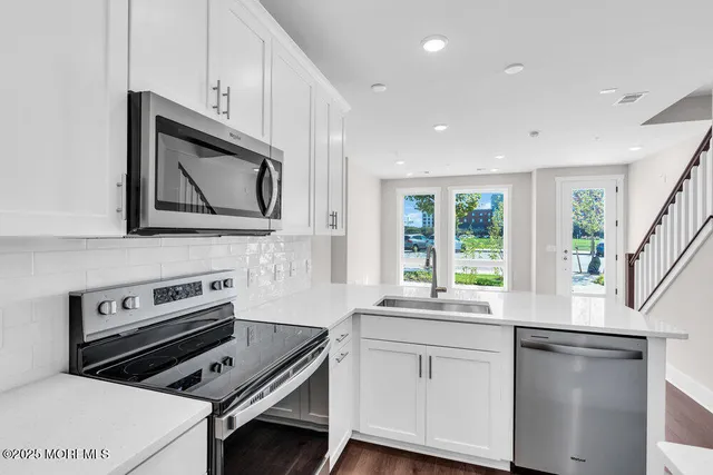 a kitchen with a stove microwave and sink