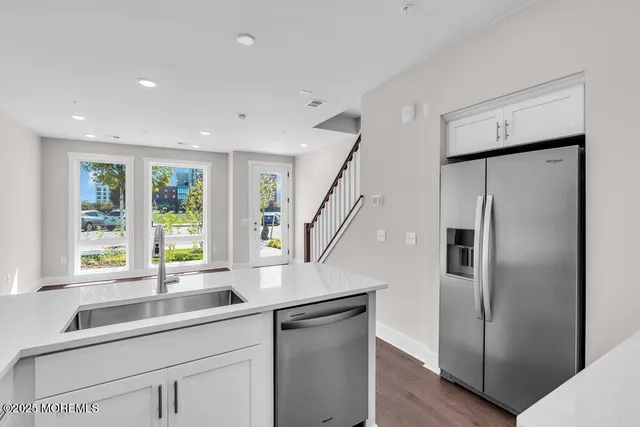 a kitchen with a sink and refrigerator