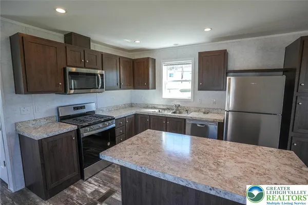 a kitchen with a refrigerator sink and microwave