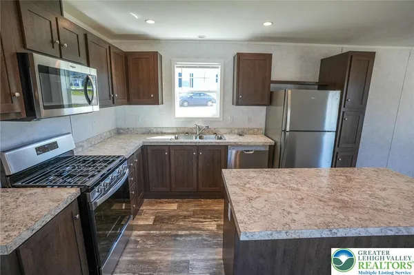 a kitchen with a sink stove and refrigerator