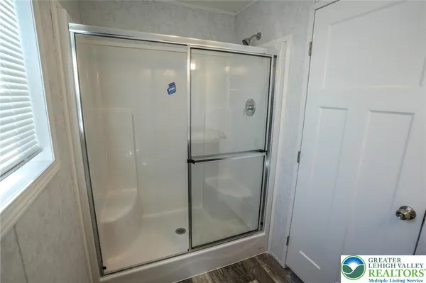 a bathroom with a glass shower door