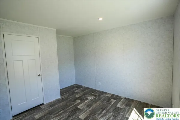 a view of a room with wooden floor and closet