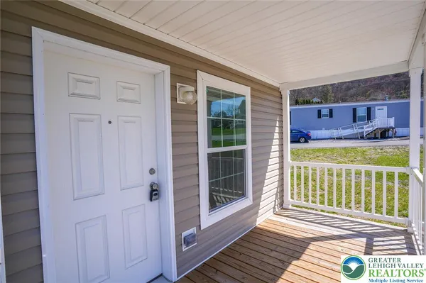 a view of a porch with wooden floor and fence