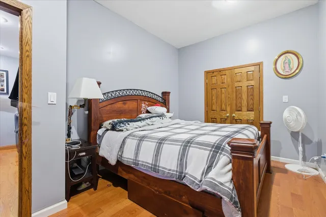 a bedroom with a bed and a painting on the wall