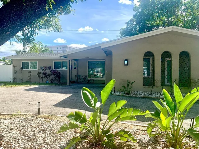 a front view of house with yard outdoor seating and green space
