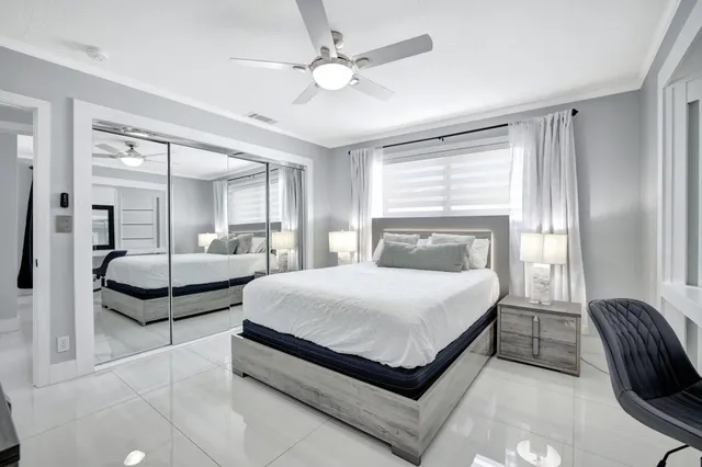 a bedroom with a large bed and a chandelier