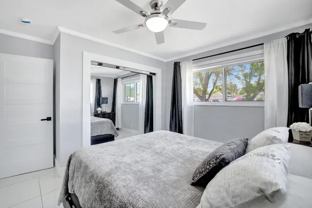 a bedroom with a large bed and a chandelier