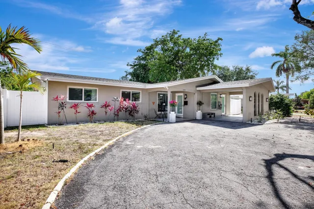 a front view of a house with plants