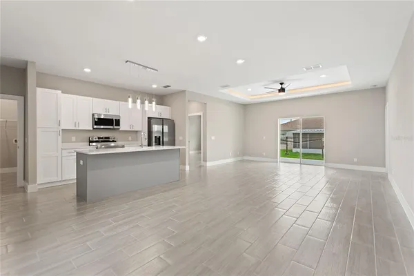 a kitchen with a sink stainless steel appliances and refrigerator