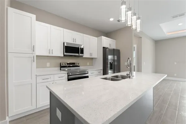 a kitchen with a sink stove and refrigerator