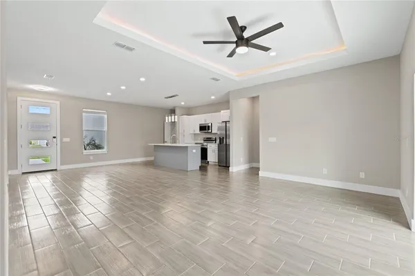 a view of a livingroom with a ceiling fan and window