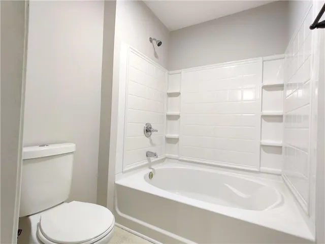 a bathroom with a bathtub and a toilet