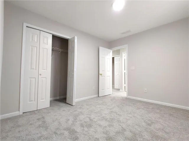 a view of an empty room and closet area