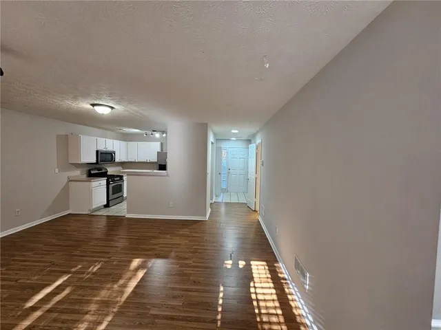 a view of a kitchen with wooden floor and kitchen