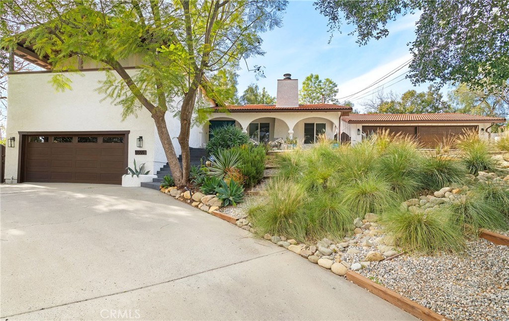 a front view of house with yard and trees around