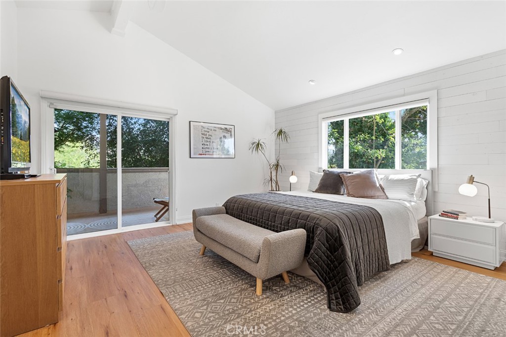 5555 Fairview Place Agoura Hills, CA 91301 - Photo 15 of 39 a spacious bedroom with a bed couch and a large window