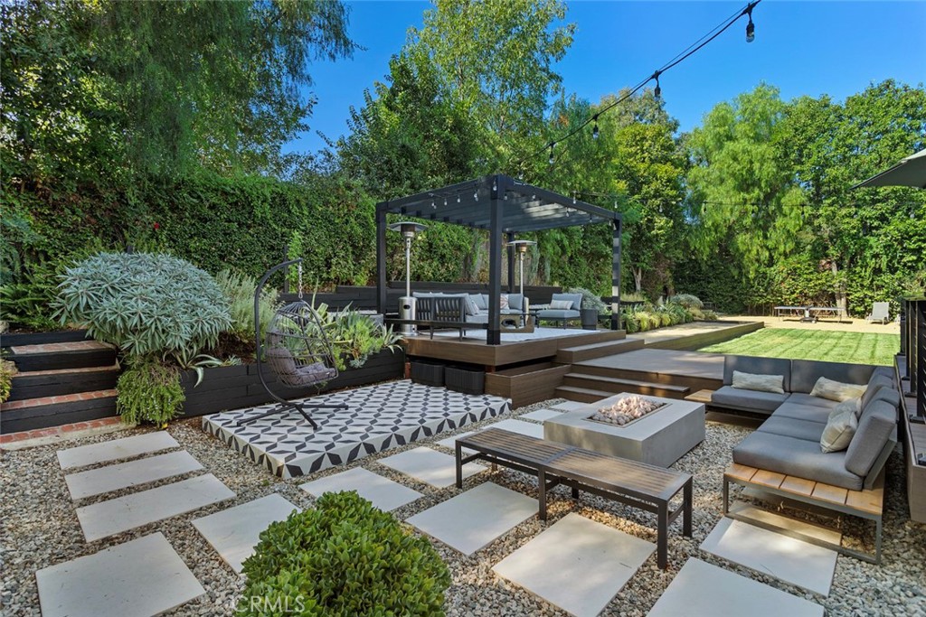 5555 Fairview Place Agoura Hills, CA 91301 - Photo 2 of 39 a backyard of a house with fire pit and outdoor seating