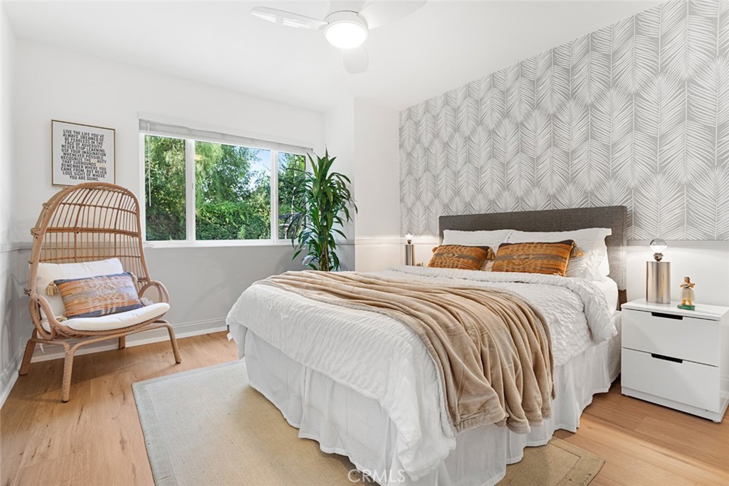 5555 Fairview Place Agoura Hills, CA 91301 - Photo 22 of 39 a bedroom with a bed and a chair