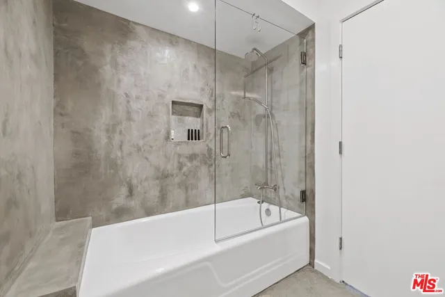 a bathroom with a bathtub and a shower