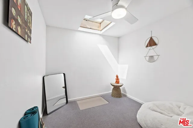 a view of a room with windows and flowerpot