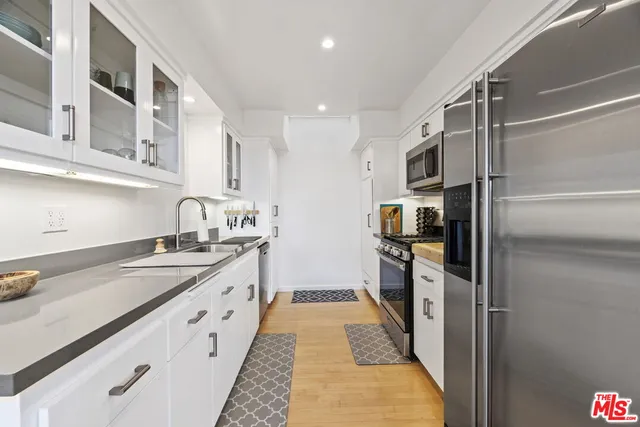 a kitchen with granite countertop stainless steel appliances a sink and counter