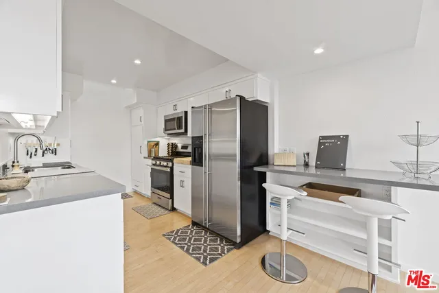 a kitchen with a refrigerator sink and stove