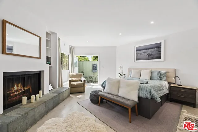 a spacious bedroom with a bed and a fireplace