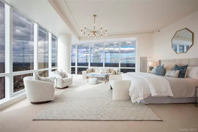 a living room with furniture and a chandelier