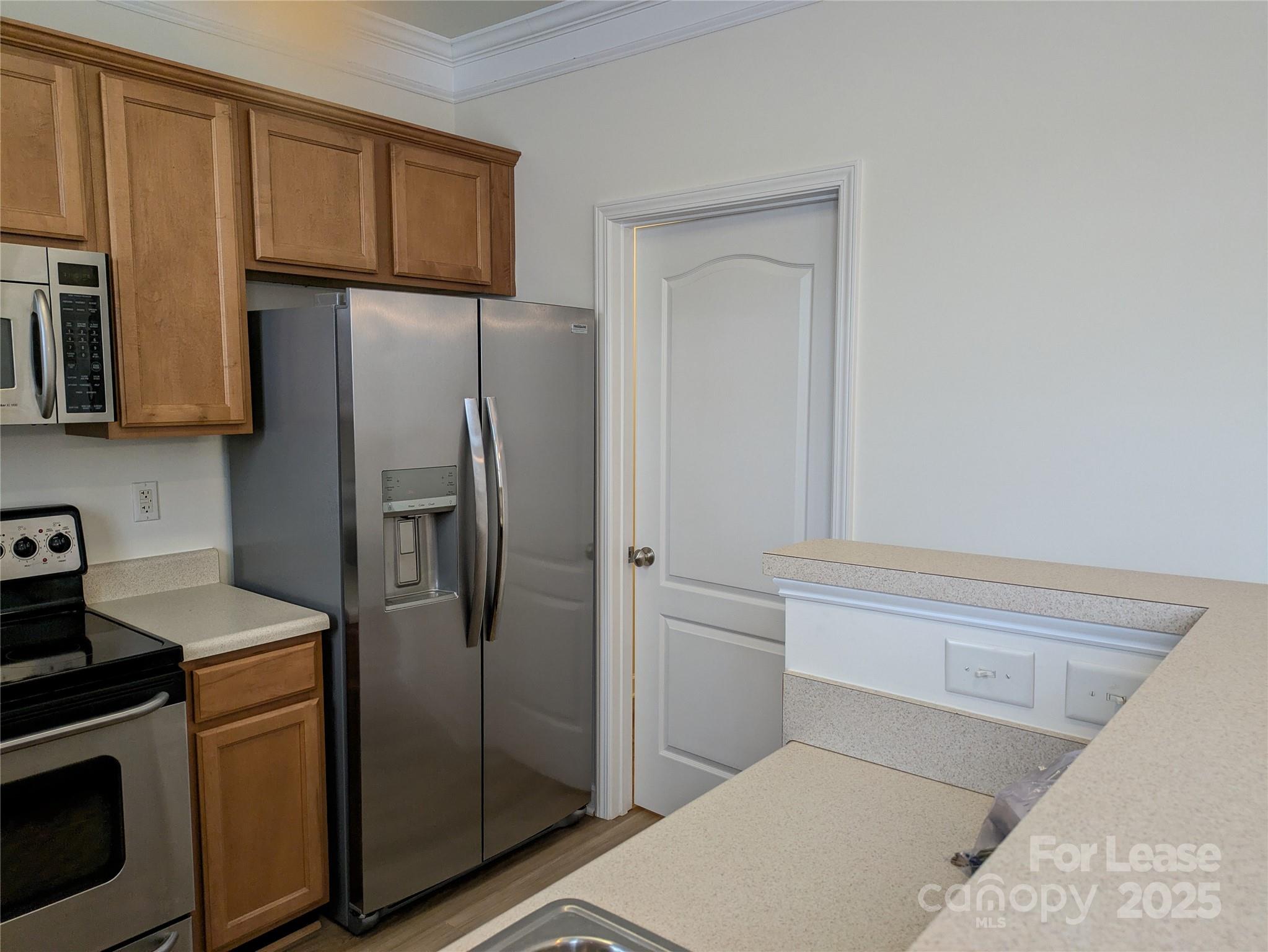 103 Chawton Lane Mooresville, NC 28117 - Photo 12 of 31 a kitchen with metallic refrigerator freezer and a dishwasher