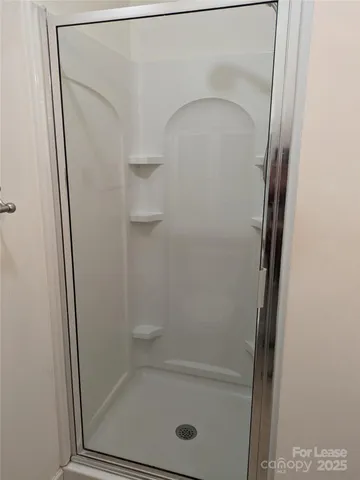 a brick house with a small yard and wooden fence