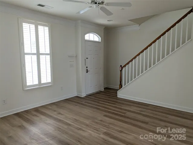 a view of an entryway with wooden floor