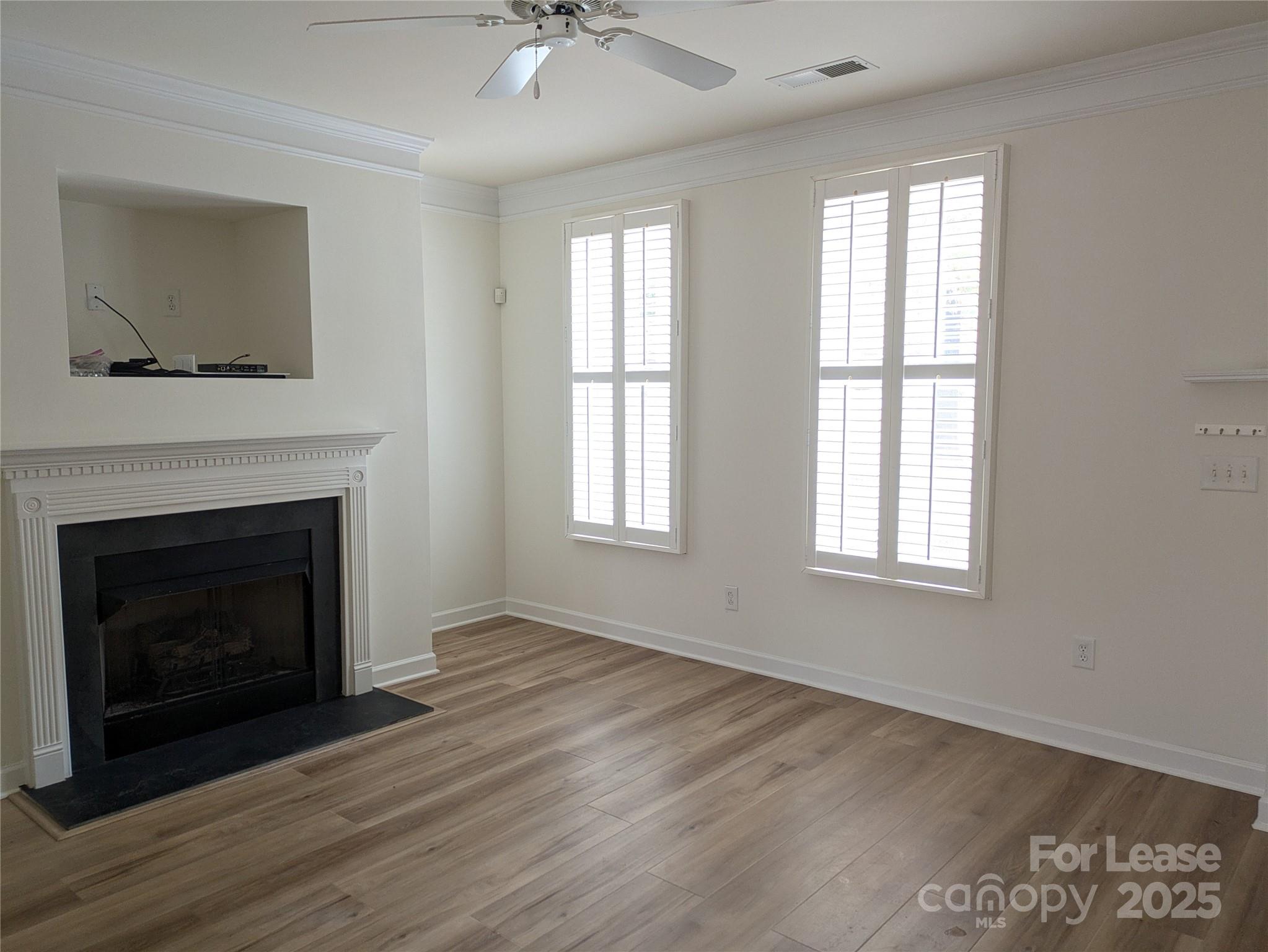 103 Chawton Lane Mooresville, NC 28117 - Photo 4 of 31 a view of an empty room with wooden floor and a fireplace